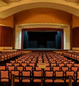 white-and-black chairs near stage inside building